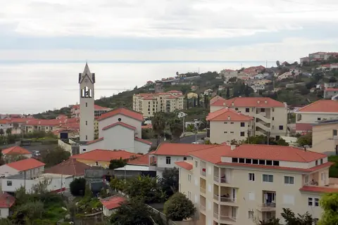 A church rises above Caniço’s tiled roofs, a landmark for exploring the town on foot.